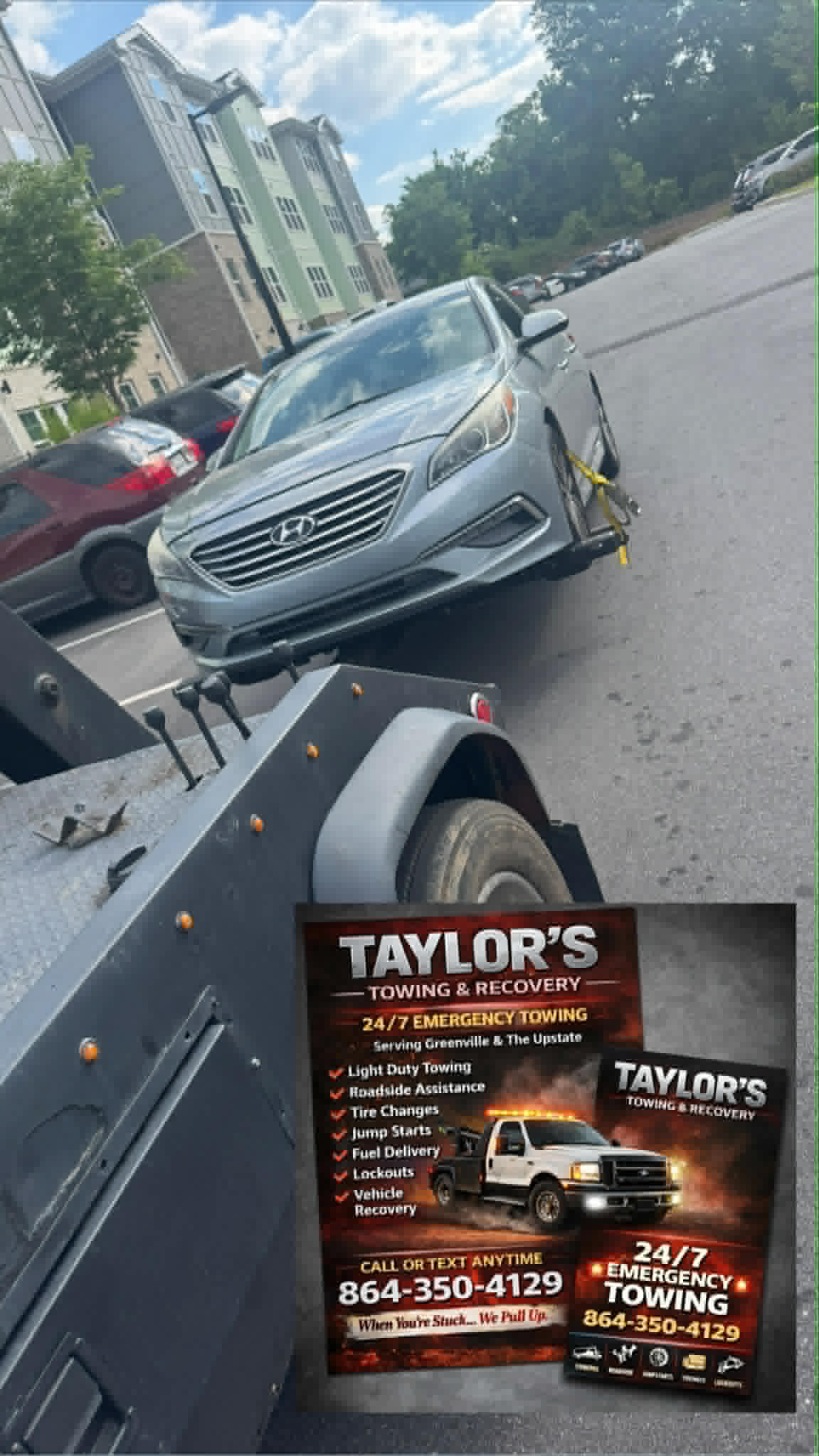 Taylor's Towing flatbed with a Hyundai Sonata at an Upstate apartment complex